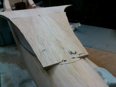 Two pieces of 1/4 sheeting sanded to the fuse bottom shape and tapered thin at the front where glued to the existing fairing bottom