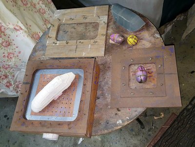 Shown 3 different size top plates and other part molds used with them.