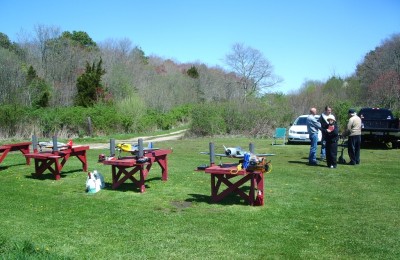 6 benches and awning covered picnic table near the parking area.